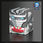 A stylized 3D render of a grey robotic cube box with red and green mechanical details, shown on a dark gradient background. A Wheeljack from Transformers made by Ultimate Guard deck box to best protect TCG Pokemon Magic The Gathering MTG Riftbound Lorcana Gundam.